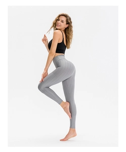 Detailed macro view of gray honeycomb texture and high-waist band on yoga leggings