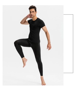 Action shot of men's PRO fitness compression top and leggings showing fabric elasticity