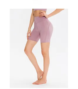 Detail view of mauve high-waisted yoga shorts with ergonomic stitching for lifting effect