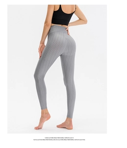 Macro detail of high-waist honeycomb texture and V-shape lifting seam on yoga leggings