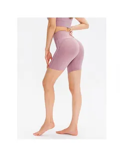 Detail view of high-waist yoga shorts in dusty pink with elastic moisture-wicking fabric