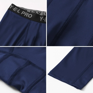 Detail of men's blue compression pants showing elastic waistband and mesh panels