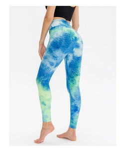Detailed close-up of honeycomb textured blue-green tie-dye high waisted yoga leggings