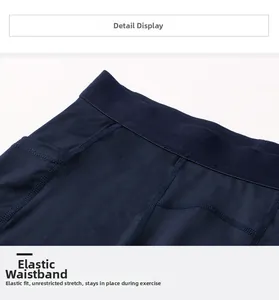 Detailed close-up of wide elastic waistband on navy blue men's compression shorts