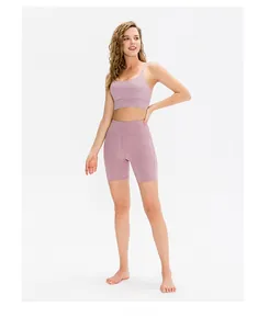 Macro shot of high-waist lilac yoga shorts and U-neck sports bra on a professional model