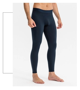 Close-up of men's navy blue compression pants with wide elastic waistband for workout
