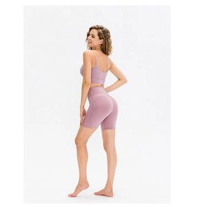 Rear view of high-waist yoga shorts and strappy sports bra in dusty pink fitness set