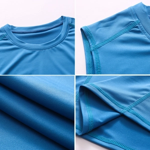 Detail view of blue quick-dry sports vest showing crew neck and reinforced stitching