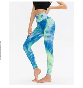 Detail of blue and green tie-dye yoga leggings with honeycomb texture and high waist