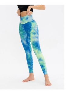 Close-up of blue and green tie-dye yoga pants with high-waisted honeycomb texture