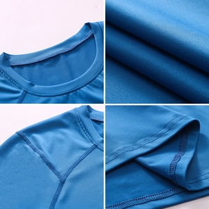 Detail view of bright blue men's compression shirt showing flatlock stitching and texture