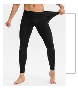 Detailed view of elastic waistband on men's compression fitness pants with high stretch