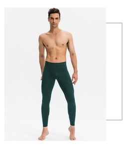 Deep green men's compression tights showing slim fit and elastic breathable fabric detail