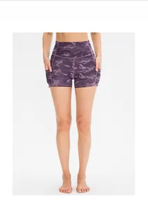 Detail view of high waisted yoga shorts with purple camo pattern and side pockets