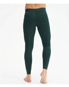 Rear view of men's dark green compression pants showing slim fit and elastic waist