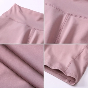 Dusty pink high waist yoga shorts featuring moisture wicking fabric and peach lift design