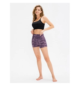 Macro shot of purple camouflage yoga shorts featuring a high-waisted seamless design