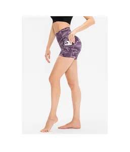 Detail of high-waisted purple camo fitness shorts with side pocket for phone storage