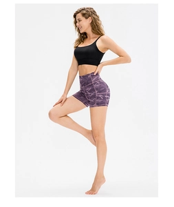 Detail of high waisted purple camo yoga shorts with elastic moisture-wicking fabric