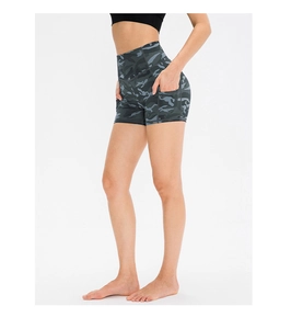 Detail of high waist camo running shorts with functional side pockets on female model