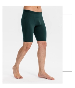 Detailed view of men's green compression shorts featuring a side pocket for phone storage