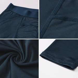 Detail of navy blue compression pants showing reinforced flatlock seams and elastic waistband