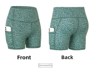 Detail view of high waist green leopard print sports shorts with functional side pockets