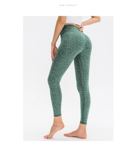 Detail showing high-waisted fitness leggings with dark green leopard print pattern