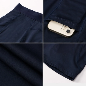 Detail view of navy compression shorts featuring side phone pocket and reinforced stitching