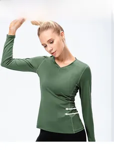 Detail of army green slim-fit yoga top featuring a V-neck and ruched side design