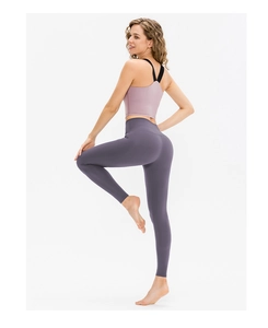 Detail shot of high-waist yoga pants showing body-shaping fit and matte fabric texture