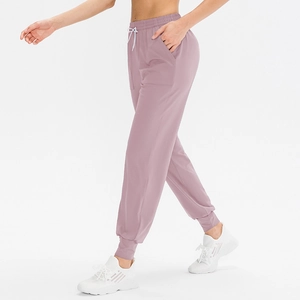 Pantaloni jogger da yoga larghi da donna color malva con coulisse elastica e tasche