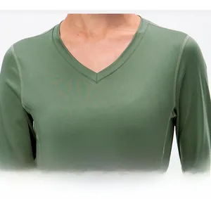 Macro detail of chic V-neck collar and high-quality knit texture on women's green yoga top