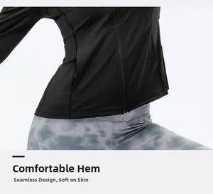 Close-up of flexible hem with flatlock stitching on women's slim-fit running jacket
