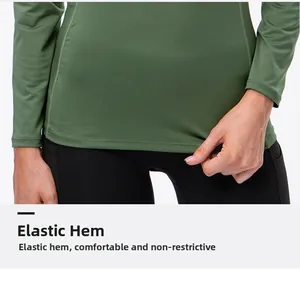 Detailed view of elastic hem on olive green long sleeve yoga top for comfort and stretch