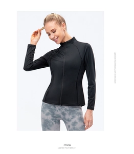 Detail of slim fit black zip-up sports jacket and grey tie-dye yoga leggings on model
