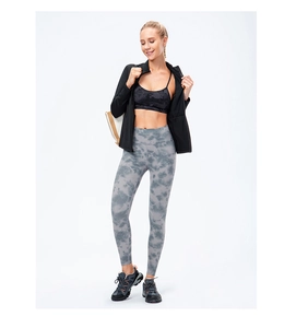 Close-up of slim-fit zipper sports jacket paired with tie-dye yoga pants and sneakers