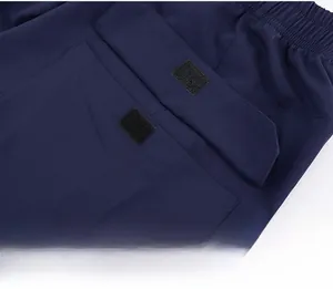 Detail of the navy blue yoga shirt featuring a secure velcro pocket for sports storage