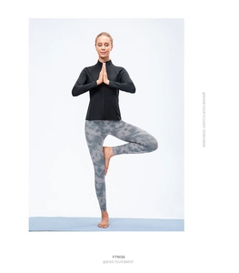 Women’s black yoga jacket and grey tie-dye leggings shown in a professional yoga pose