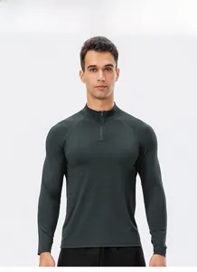 Detail view of dark green athletic sweatshirt with half-zip collar and raglan sleeve design