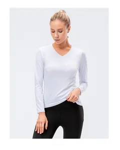 Close-up of white slim-fit long-sleeve yoga top with V-neck and stretch fabric