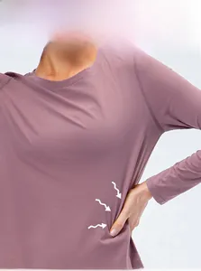 Detail showing the high-elasticity purple fabric and reinforced stitching of yoga shirt