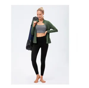 Close-up of three-piece fitness set including green jacket, grey bra and black leggings