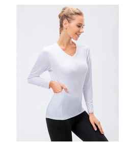Close-up of white V-neck sports top featuring a functional side pocket for storage