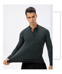 Close-up of dark green sports top showing high elasticity and durable half-zip collar