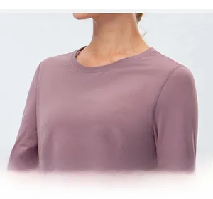 Detail of classic crew neck and smooth fabric texture on dusty pink yoga long sleeve shirt