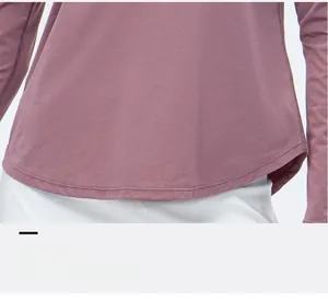 Detail of the curved hem and stretch fabric texture on women's purple yoga top