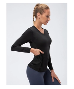 Close-up of functional hidden side pocket on black long-sleeve women's workout shirt