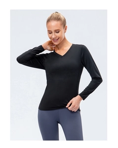 Detail of women's slim fit V-neck long sleeve black yoga top in breathable stretch fabric