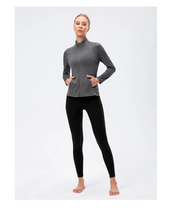 Detail of the high-waisted black yoga leggings paired with a grey zip-up sports jacket